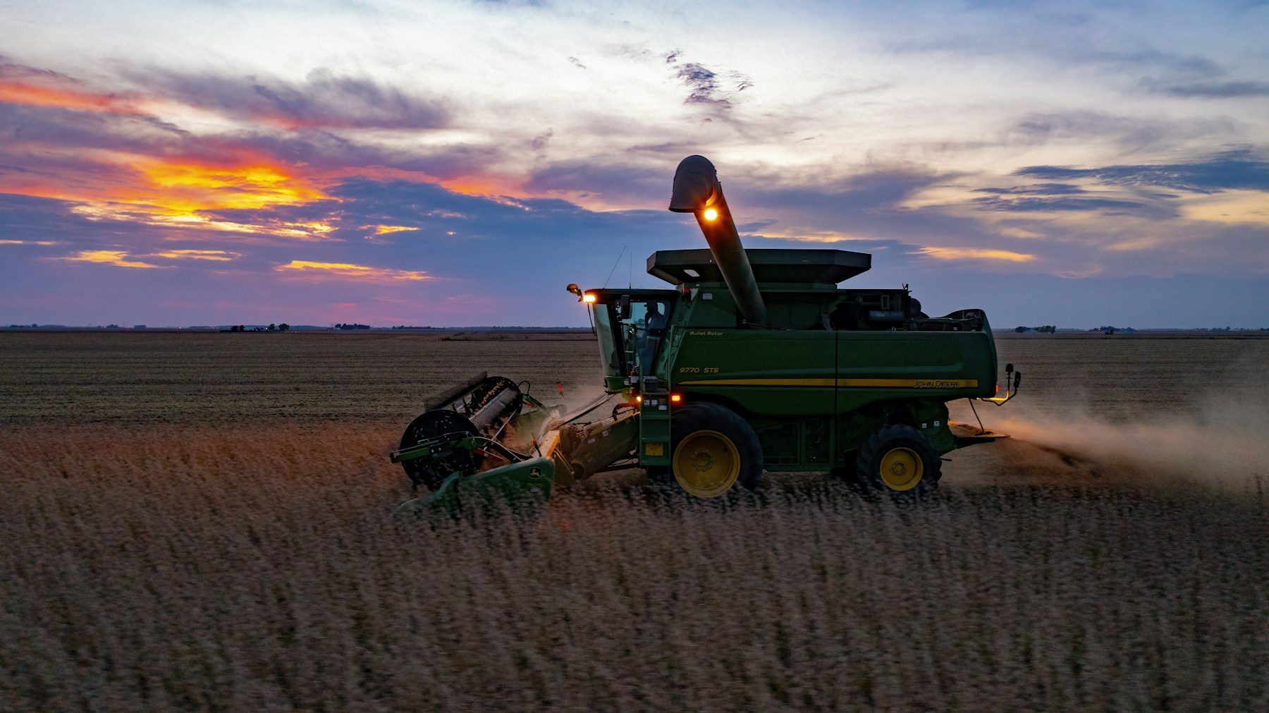 Harvester working a field of crops